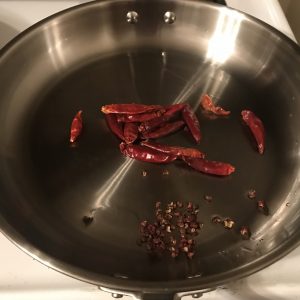 Infusing the oil with peppercorn and chili