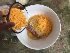 Pour cheddar cheese into bowl